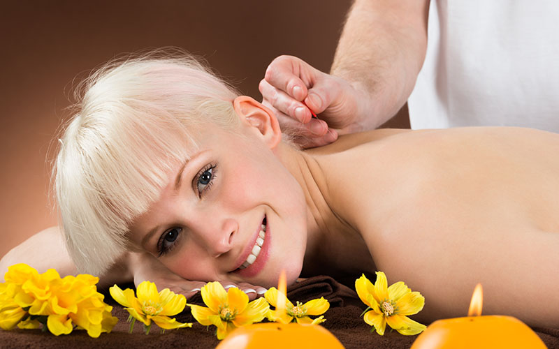 Young Woman Receiving Acupuncture Treatment